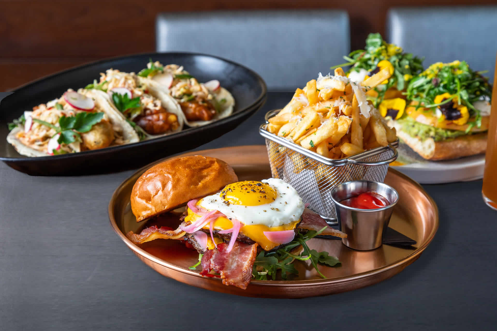 Burger, hot wings, and avocado toast at Jimmy's on First.